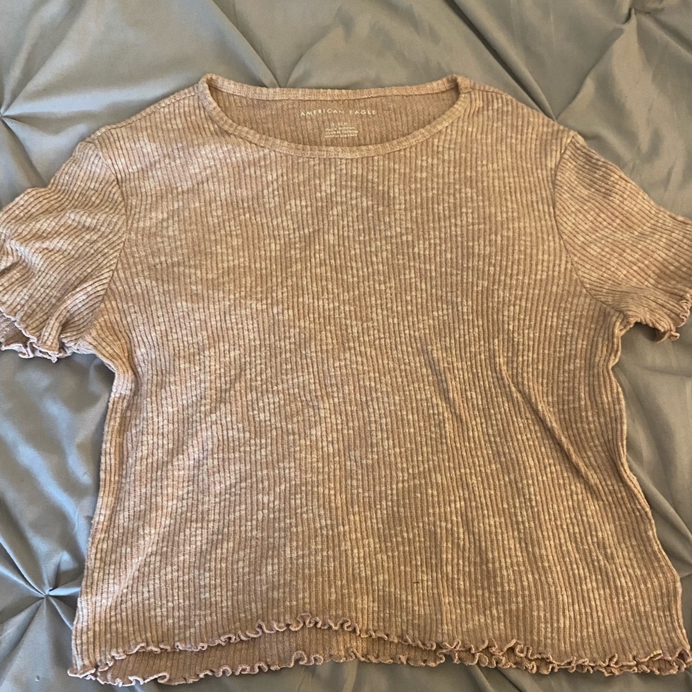 Size Medium top from American Eagle that is made with stretchy material.